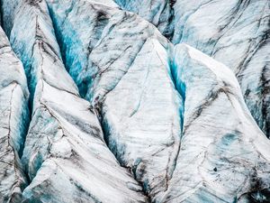 A detailed, close-up photograph of a glacier's surface, showing sharp white peaks, vibrant blue ice in deep crevasses, and layers of dark sediment. clear and transparent commitment to GDPR compliance.