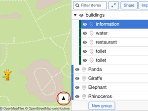 A screenshot of a custom MapHub zoo map showing the new directions button, an arrow icon for route planning, displayed in the bottom-right corner. access to route planning from their location to a selected point.