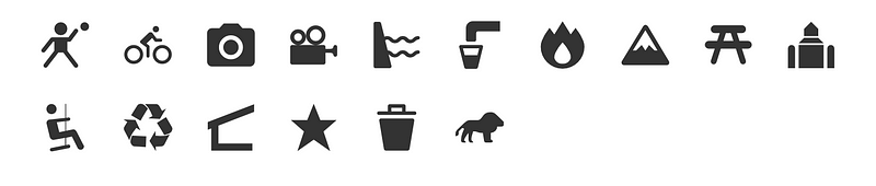 A visual display of 15 new dark grey map icons for MapHub, arranged in two rows. The icons represent diverse points of interest, including a cyclist, a mountain, a camera, a picnic table, and a recycling symbol. Maki, Font Awesome, and Google Material icon sets.