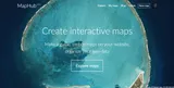 A screenshot of the MapHub homepage, featuring the tagline 'Create interactive maps' over a vibrant satellite image of a tropical atoll, representing the updated mapping tool. by a completely rewritten platform for creating interactive maps.'