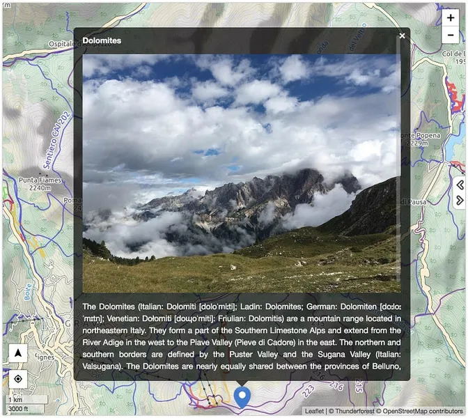 Desktop view of a MapHub map with a large popup displaying a high-resolution image of the Dolomites and descriptive text, illustrating the improved popup size.