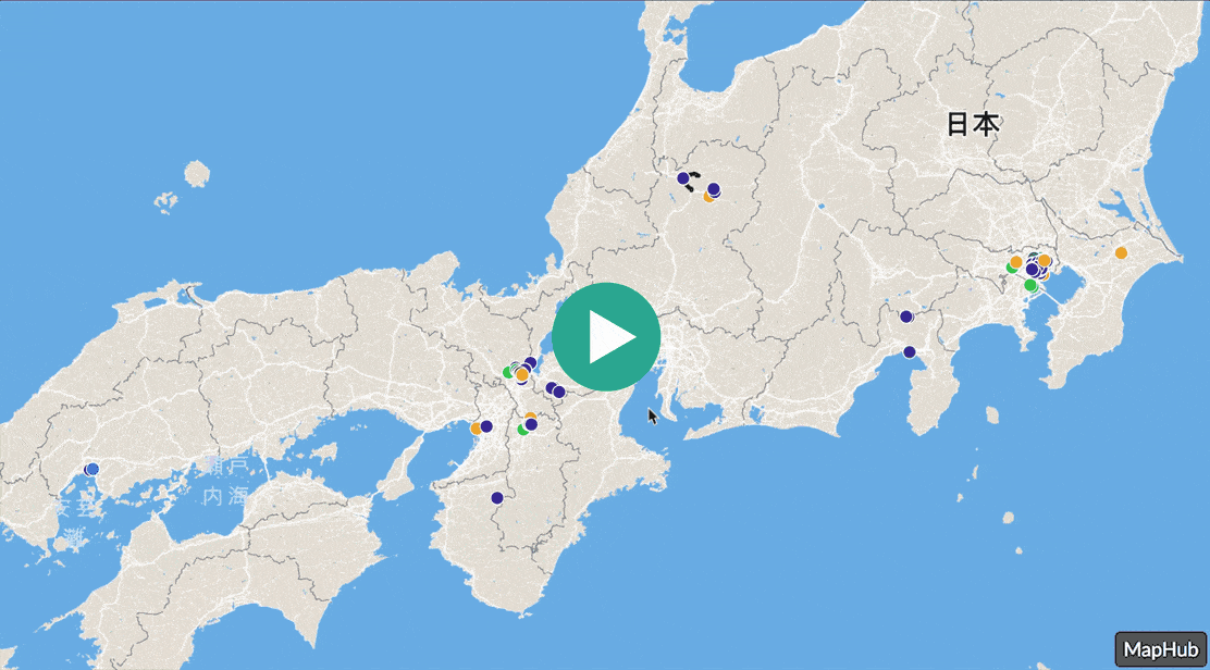 A map of Japan with various colored markers, centered with a large green play button icon, demonstrating the loading animation of a MapHub HD embed.