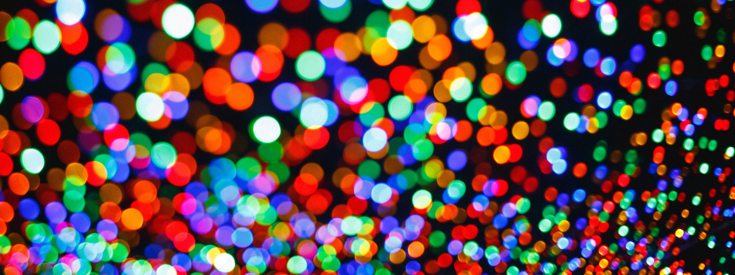 An abstract header image showing out-of-focus colorful bokeh lights, which represent the simplified data points on a dense, interactive map. helps declutter the view for a better user experience.