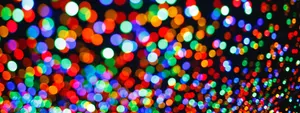 An abstract header image showing out-of-focus colorful bokeh lights, which represent the simplified data points on a dense, interactive map. helps declutter the view for a better user experience.